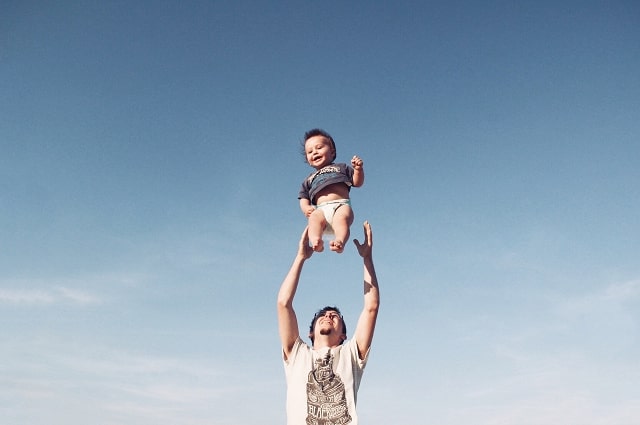 Father’s Day Gift Ideas for Every Kind of Dad, image of a dad throwing his son in the air in a playful way.
